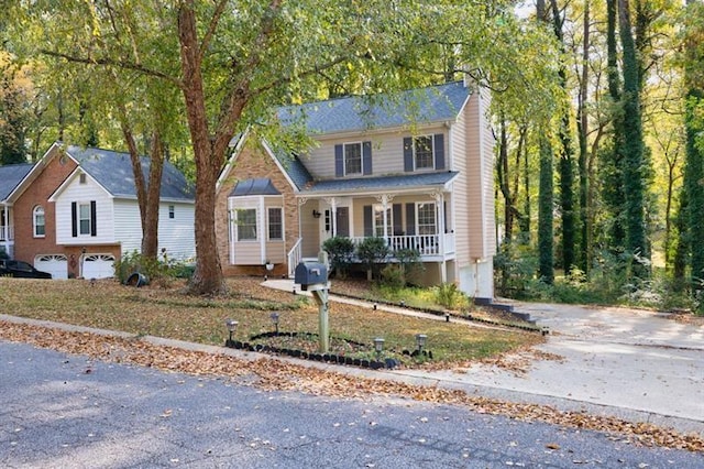 view of front facade featuring covered porch and a garage