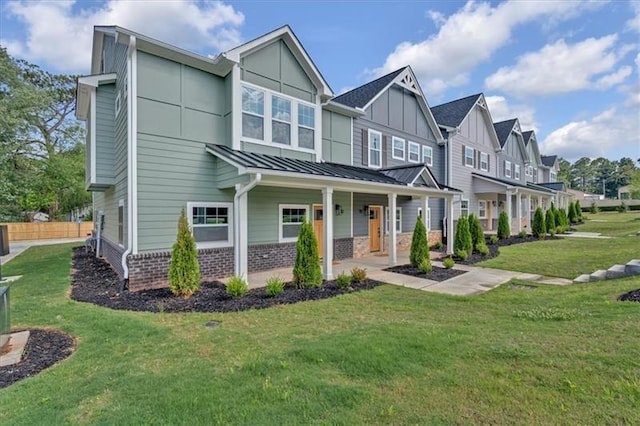 view of front of house with a front yard and covered porch