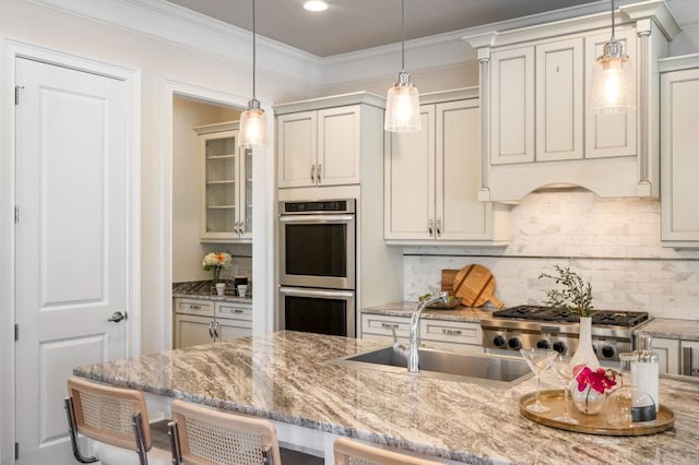 kitchen with tasteful backsplash, decorative light fixtures, a breakfast bar area, and stainless steel double oven