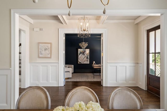 interior space featuring beamed ceiling, crown molding, dark hardwood / wood-style floors, and a chandelier