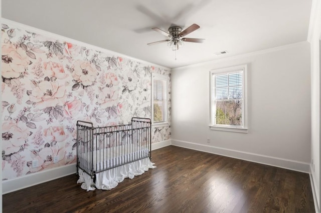 bedroom featuring crown molding, dark hardwood / wood-style flooring, and ceiling fan