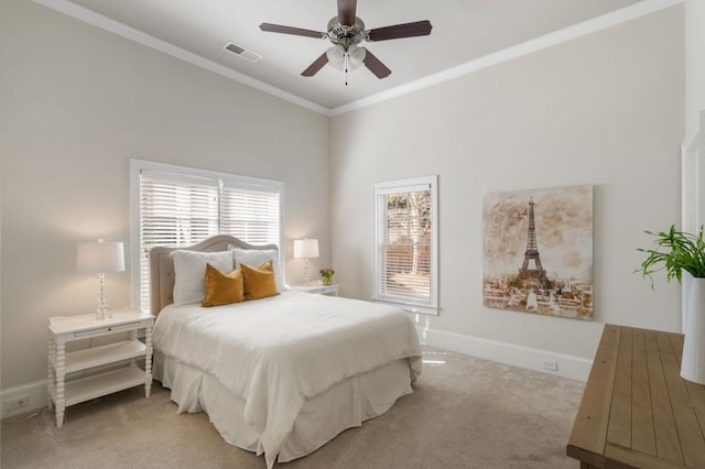 bedroom featuring light colored carpet, ornamental molding, and ceiling fan