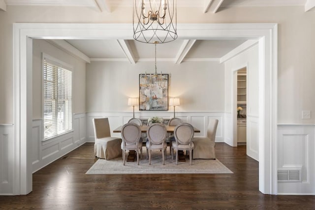 dining room featuring dark hardwood / wood-style floors, beam ceiling, and a notable chandelier