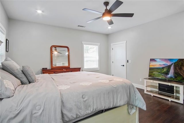 bedroom with dark hardwood / wood-style floors and ceiling fan