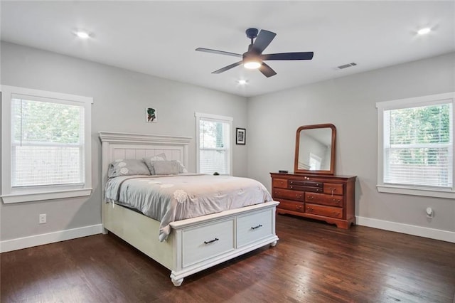 bedroom with dark hardwood / wood-style floors and ceiling fan