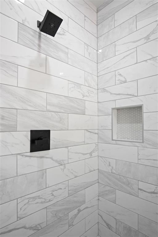 bathroom with a tile shower