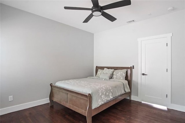 bedroom with dark hardwood / wood-style floors and ceiling fan