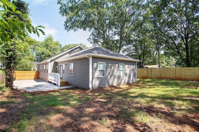 back of property featuring a yard and a patio area