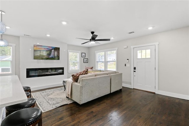 living room with dark hardwood / wood-style floors and ceiling fan