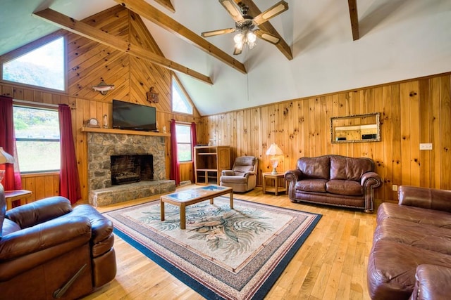 living room featuring light hardwood / wood-style floors, high vaulted ceiling, and beamed ceiling