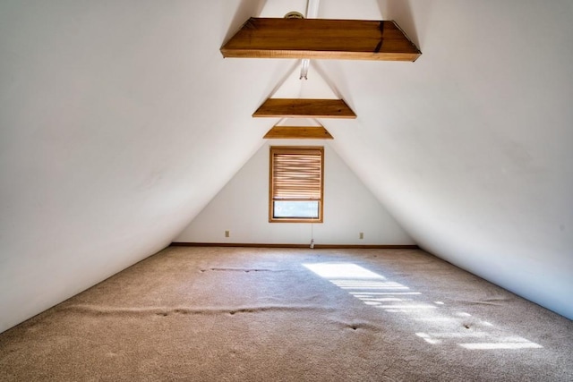 bonus room with lofted ceiling and carpet