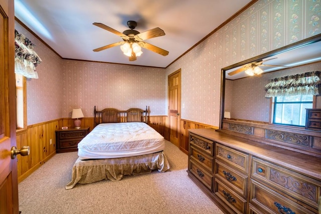 bedroom featuring wood walls, ornamental molding, light colored carpet, and ceiling fan