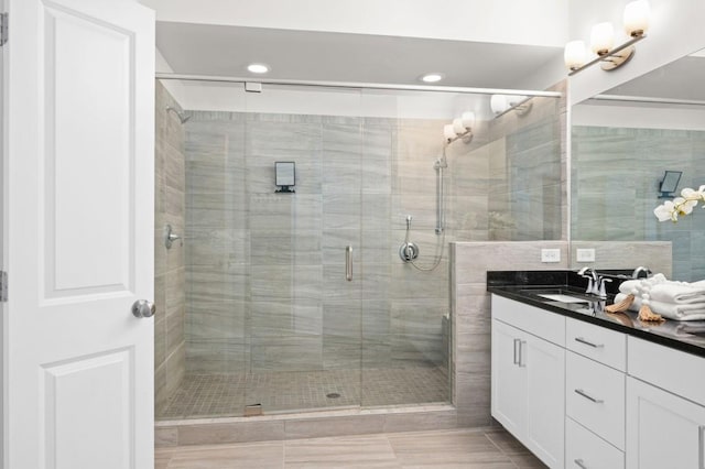 full bathroom with a shower stall and vanity