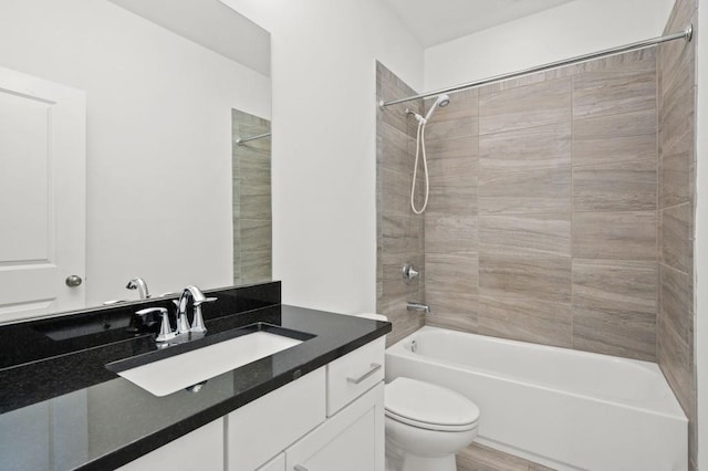 full bath featuring tub / shower combination, vanity, and toilet