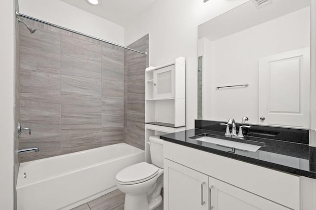 full bathroom featuring toilet, visible vents,  shower combination, and vanity