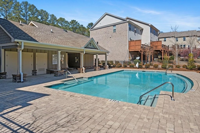 community pool featuring a patio and fence