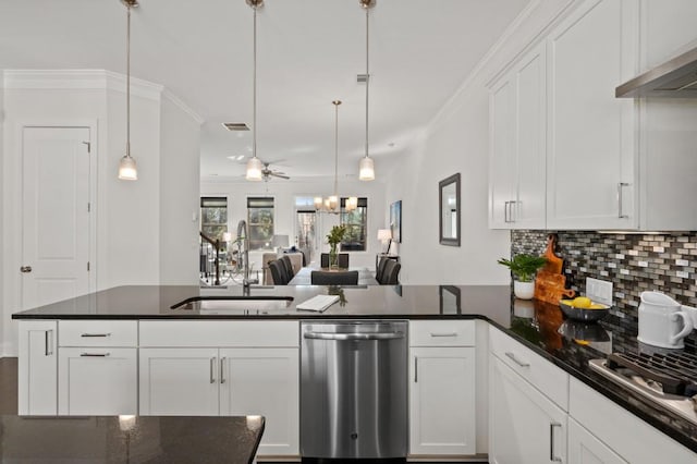 kitchen with stainless steel appliances, a peninsula, a sink, white cabinets, and ornamental molding