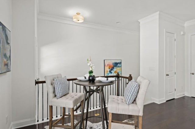 dining room with baseboards, ornamental molding, and dark wood-type flooring