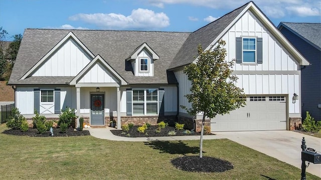 modern farmhouse style home featuring a garage, driveway, board and batten siding, and a front yard