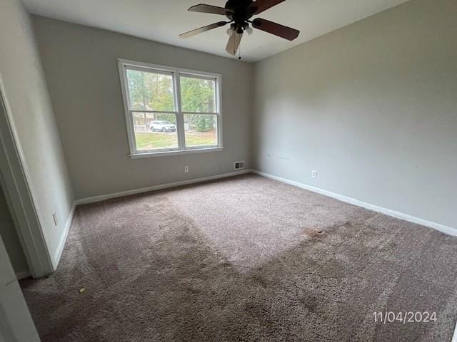 carpeted empty room featuring ceiling fan