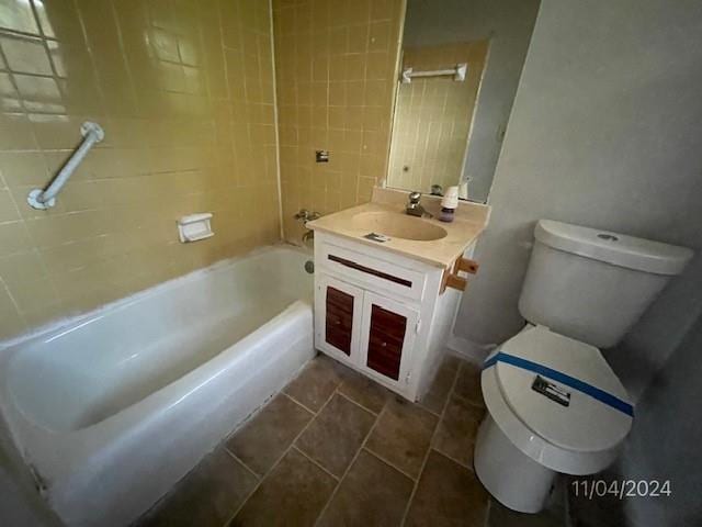 full bathroom with vanity, tiled shower / bath combo, and toilet