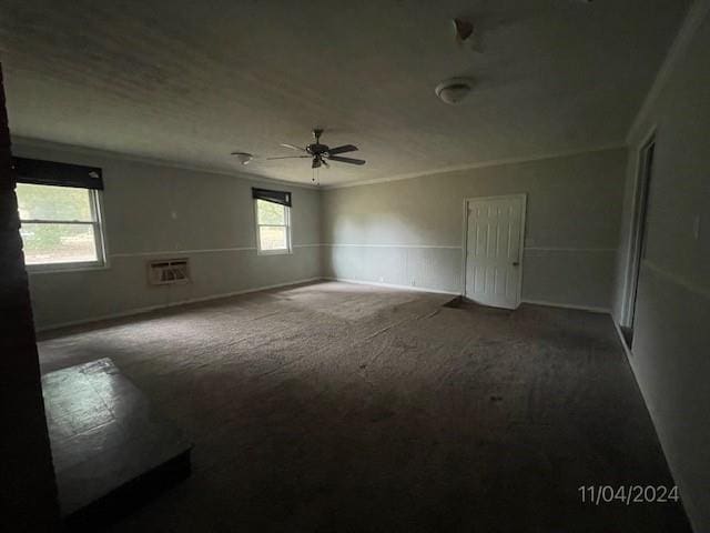 spare room with carpet flooring, a wall mounted AC, and ceiling fan