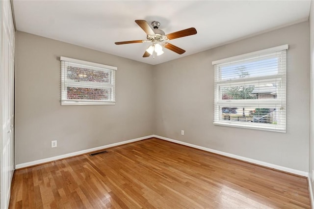 empty room featuring ceiling fan and light hardwood / wood-style floors