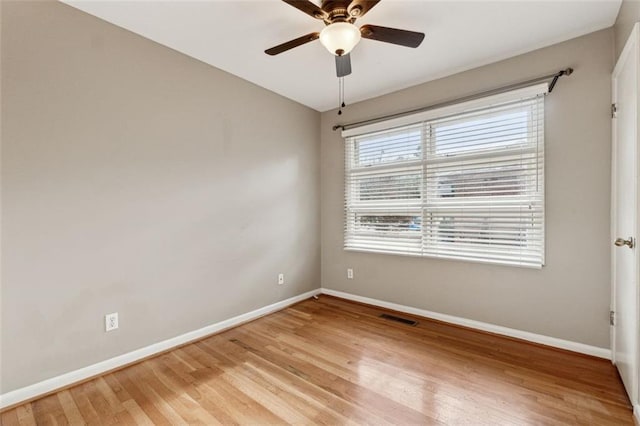 empty room with ceiling fan and light hardwood / wood-style floors