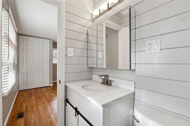 bathroom with vanity, toilet, and wood-type flooring