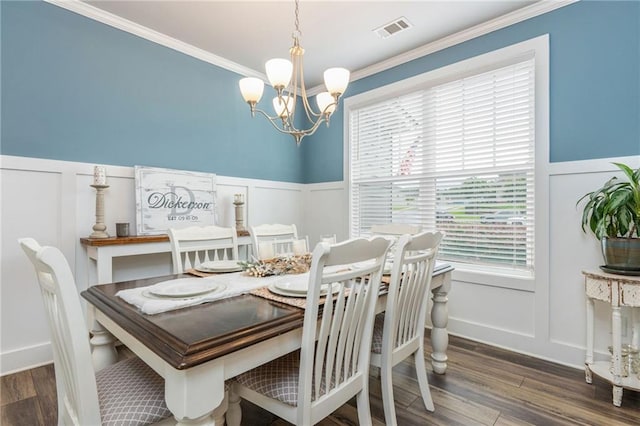 48 Violet Ln, Dallas, GA 30132 - dining space with a decorative wall, a chandelier, a wainscoted wall, and wood finished floors