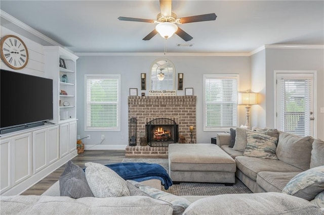 48 Violet Ln, Dallas, GA 30132 - living room with wood finished floors, ceiling fan, a brick fireplace, ornamental molding, and baseboards