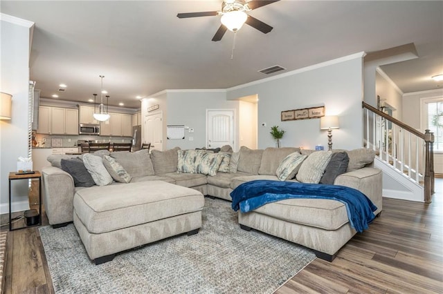 48 Violet Ln, Dallas, GA 30132 - living area featuring dark wood finished floors, ornamental molding, ceiling fan, stairs, and baseboards