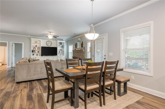48 Violet Ln, Dallas, GA 30132 - dining room featuring ornamental molding, dark wood finished floors, ceiling fan, baseboards, and built in shelves