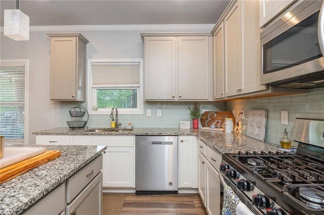 48 Violet Ln, Dallas, GA 30132 - kitchen featuring appliances with stainless steel finishes, a sink, dark wood-style floors, decorative backsplash, and light stone counters