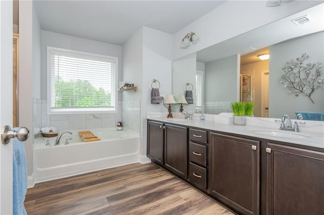 48 Violet Ln, Dallas, GA 30132 - bathroom featuring double vanity, a garden tub, and wood finished floors