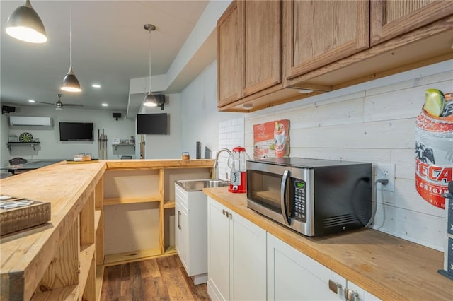 48 Violet Ln, Dallas, GA 30132 - kitchen with stainless steel microwave, wood counters, a wall mounted air conditioner, a sink, and recessed lighting