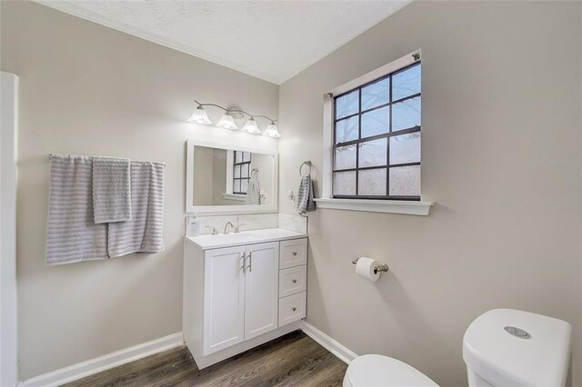 bathroom with hardwood / wood-style floors, vanity, and toilet