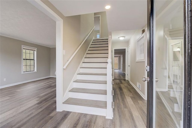 staircase featuring wood-type flooring