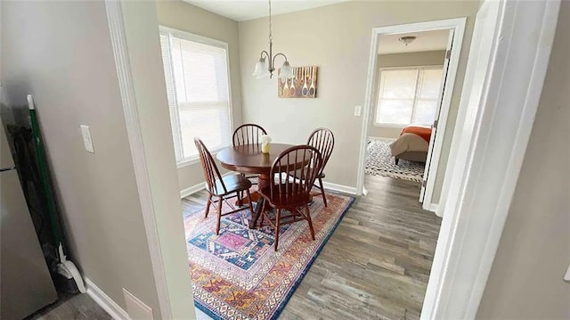554 Holderness St SW, Atlanta, GA 30310 - dining space with baseboards, wood finished floors, and an inviting chandelier