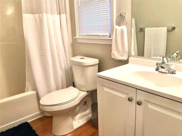 554 Holderness St SW, Atlanta, GA 30310 - bathroom featuring wood finished floors, toilet, vanity, and shower / bathtub combination with curtain
