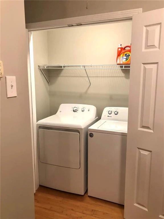 554 Holderness St SW, Atlanta, GA 30310 - laundry room featuring light wood-style flooring, washing machine and clothes dryer, and laundry area
