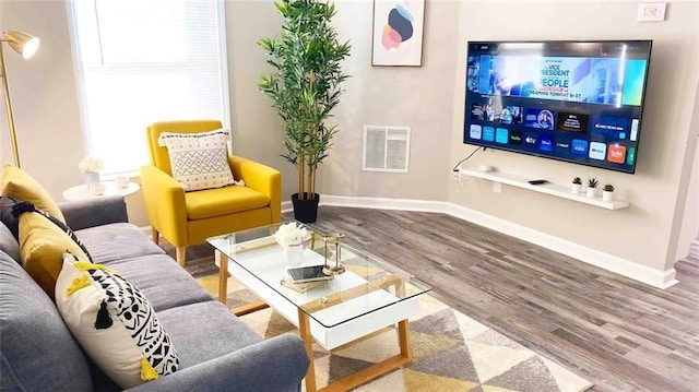 554 Holderness St SW, Atlanta, GA 30310 - living room featuring baseboards, visible vents, and wood finished floors