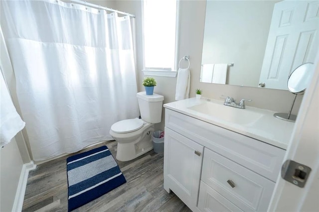 554 Holderness St SW, Atlanta, GA 30310 - bathroom featuring toilet, vanity, a shower with shower curtain, and wood finished floors