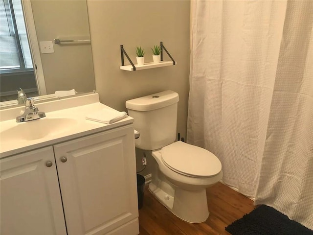 554 Holderness St SW, Atlanta, GA 30310 - full bath with toilet, a shower with shower curtain, vanity, and wood finished floors