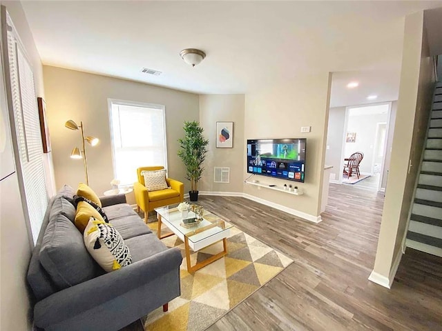 554 Holderness St SW, Atlanta, GA 30310 - living room with visible vents, baseboards, stairway, and wood finished floors