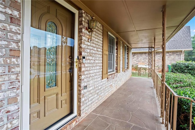 view of exterior entry with a porch