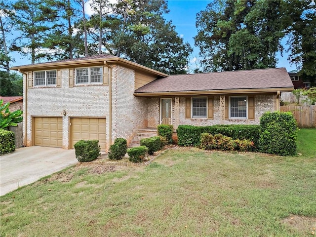 tri-level home with a garage and a front yard