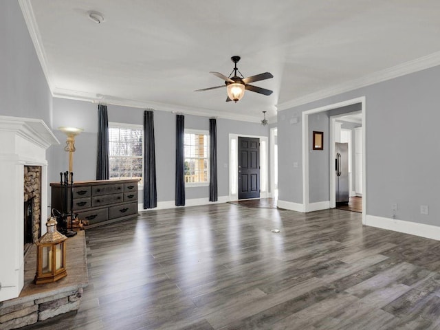 unfurnished living room featuring dark hardwood / wood-style floors, ornamental molding, and a stone fireplace