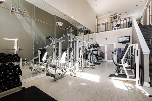 3777 Peachtree Rd NE Unit 1007, Atlanta, GA 30319 - workout area with a towering ceiling, a chandelier, and wood finished floors