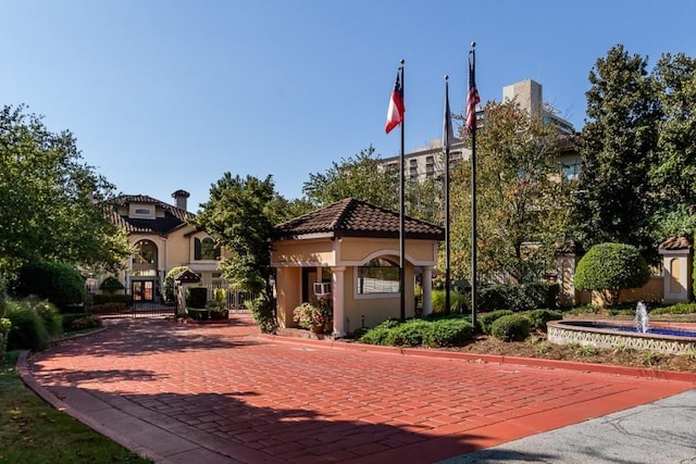 3777 Peachtree Rd NE Unit 1007, Atlanta, GA 30319 - view of front of property featuring a gate, stucco siding, and a tile roof